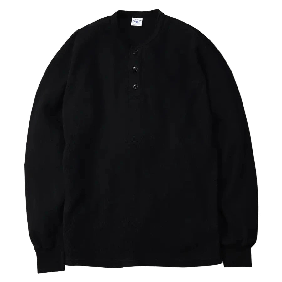 Black long-sleeve shirt on a gray background