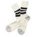 A pair of cream-colored knit socks with black and white horizontal stripes on the calf and gray toe and heel sections, displayed on a clean white background.