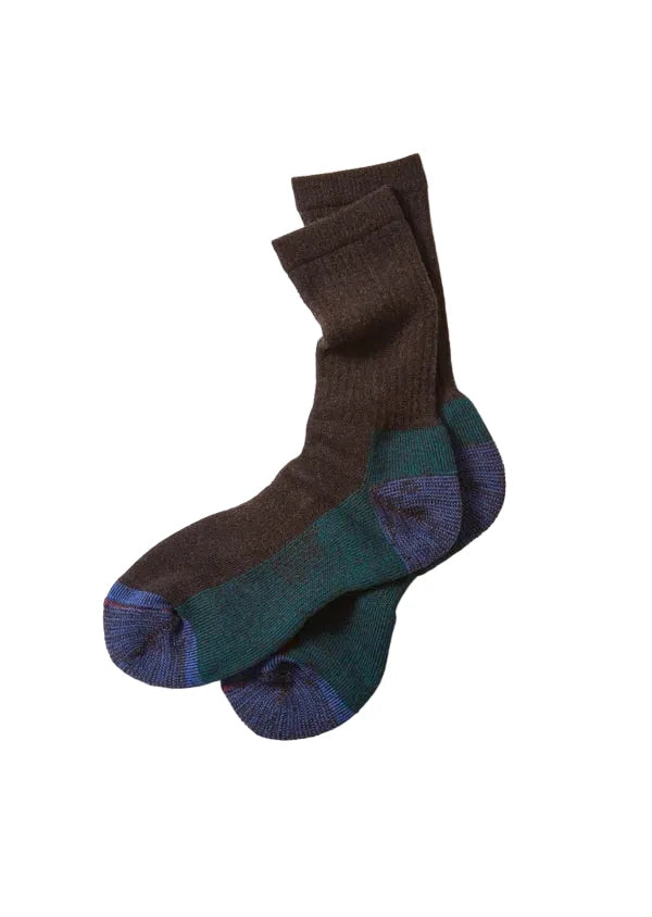 A pair of crew socks with a color-blocked design, featuring a dark brown upper, a dark teal green midsection, and a blue patterned toe and heel section, laid flat on a white background.