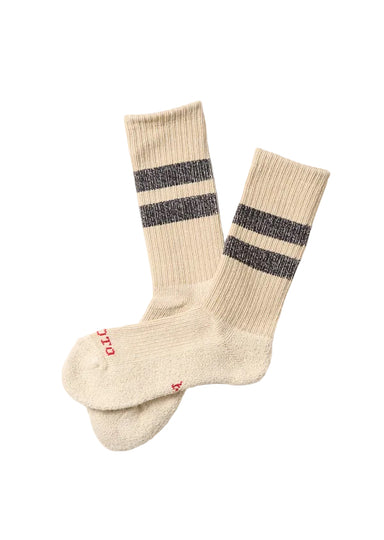 Pair of beige socks with black stripes on a white background