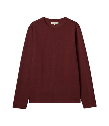 A dark burgundy long-sleeve crewneck sweater laid flat against a light off-white background.