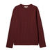 A dark burgundy long-sleeve crewneck sweater laid flat against a light off-white background.