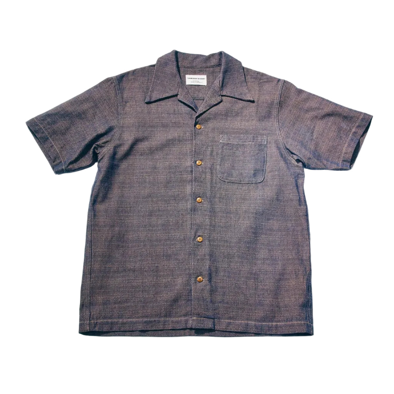 Short-sleeve shirt with button details on a light gray background
