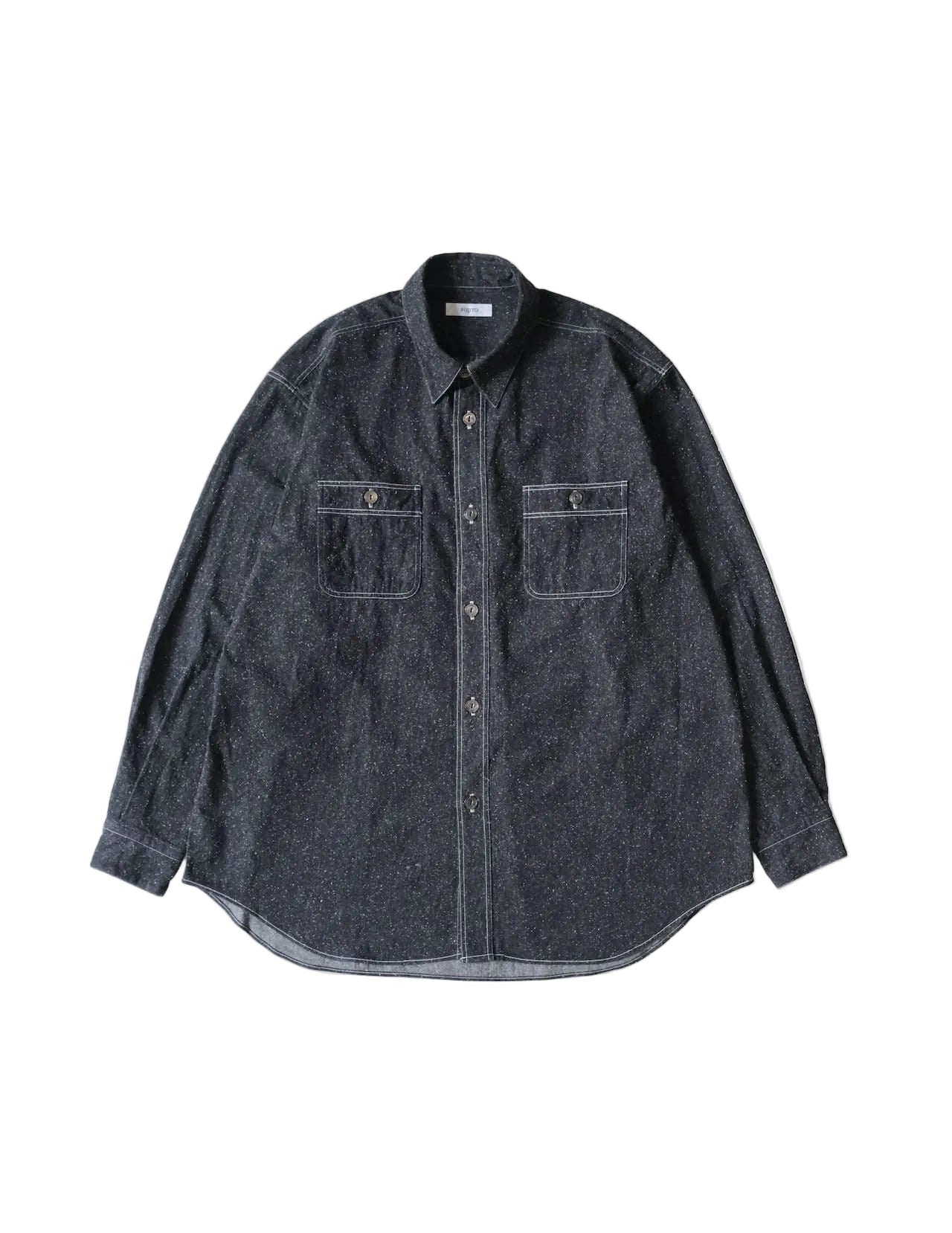 A dark gray indigo chambray button-down shirt with two chest pockets, laid flat against a light cream background.