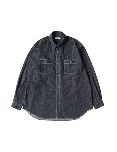 A dark gray indigo chambray button-down shirt with two chest pockets, laid flat against a light cream background.