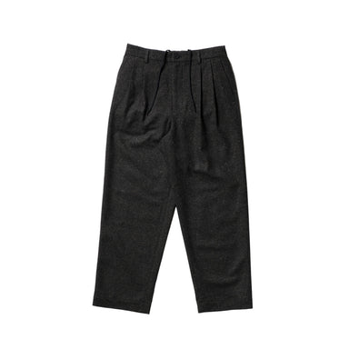 A pair of dark charcoal gray pleated wool trousers laid flat against a clean white background.
