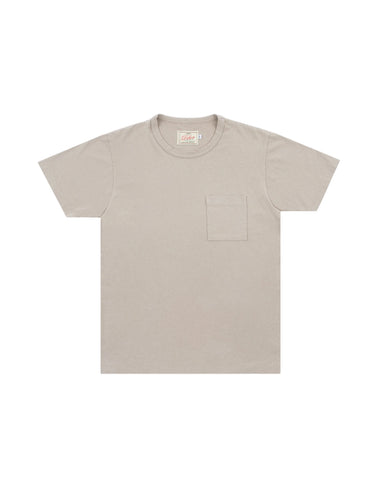 A light beige crewneck t-shirt with a single chest pocket, displayed flat against a light gray background.