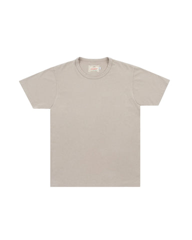 A light beige crewneck t-shirt with short sleeves, laid flat against a light gray background.