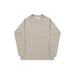 A light beige long-sleeve crewneck shirt with a single chest pocket, laid flat against a light gray background.