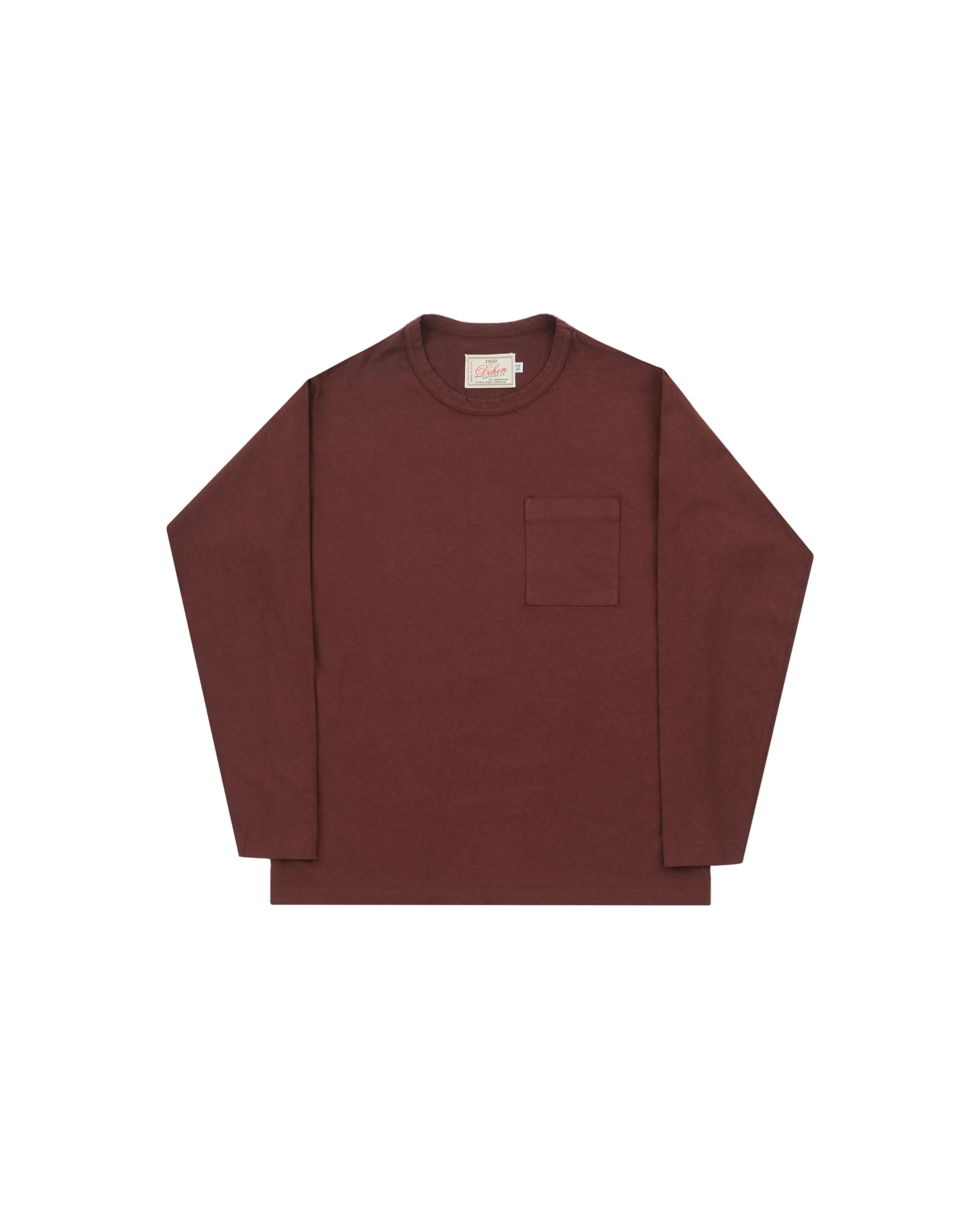 A dark reddish-brown long-sleeve crewneck shirt with a single chest pocket, laid flat against a light gray background.