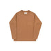 A long-sleeve crewneck shirt in a warm camel brown color, featuring a single patch pocket on the left chest, laid flat against a light gray background.