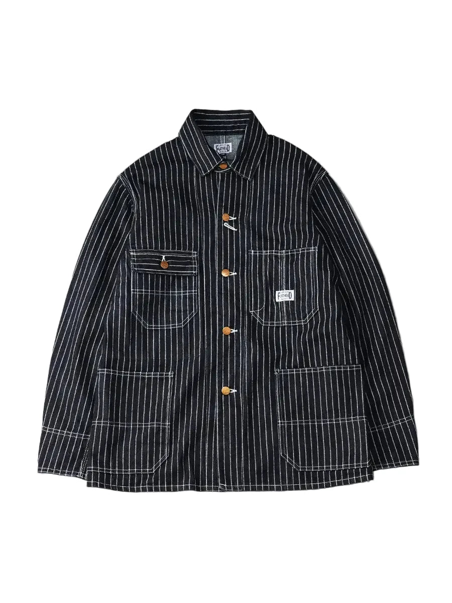 A dark navy blue corduroy jacket with white vertical pinstripes, featuring orange buttons and a white brand patch on the chest pocket, displayed against a neutral gray background.