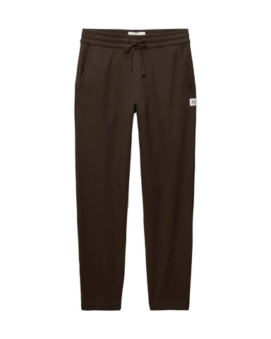 Dark brown jogger pants with an elastic drawstring waist and a small white brand tag on the left hip, shown flat against a light gray background.