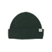 A dark forest green ribbed knit beanie hat with a folded cuff and a small white brand tag on the side, shown against a plain white background.