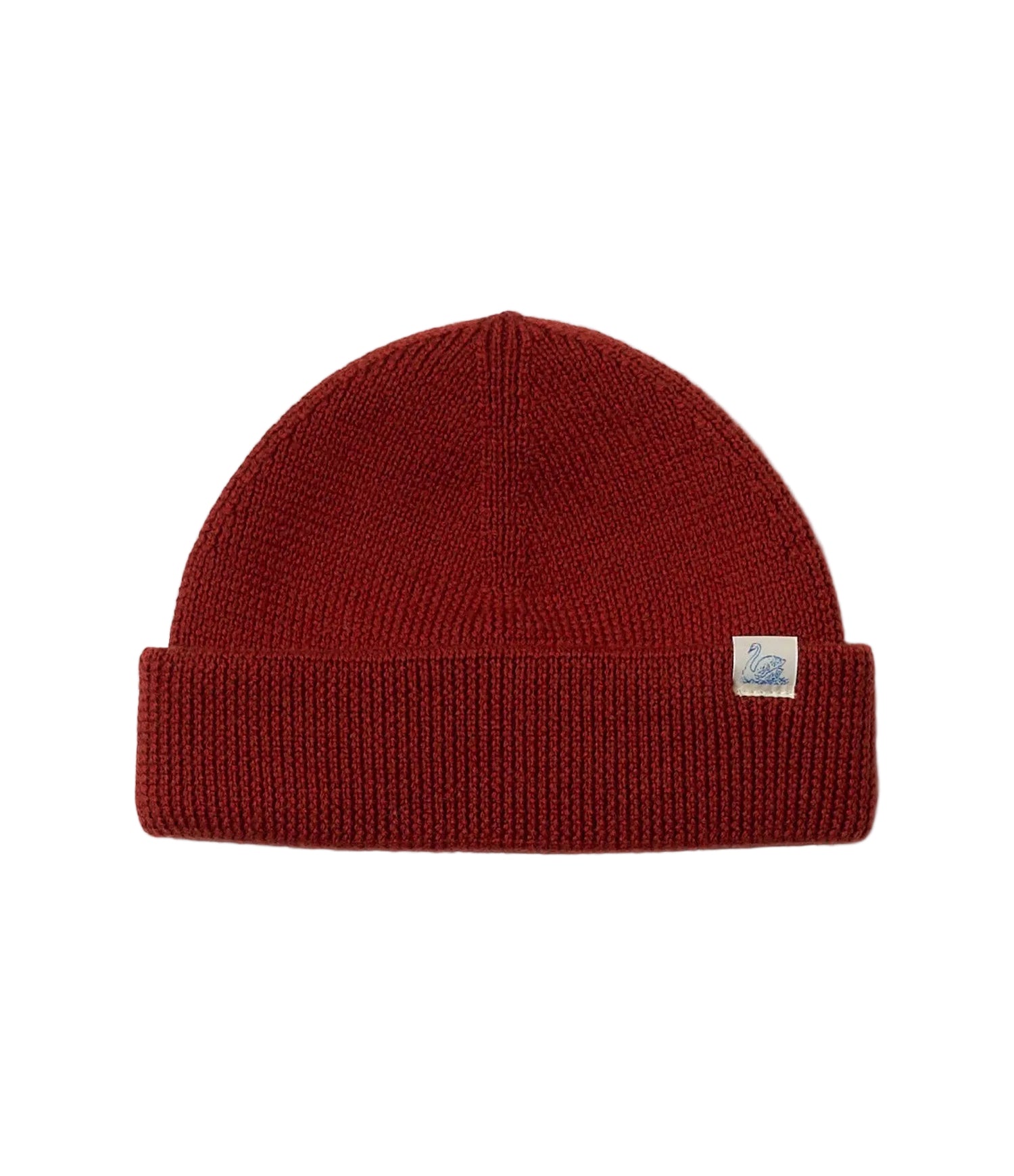 Red knit beanie with a brand label on a light gray background