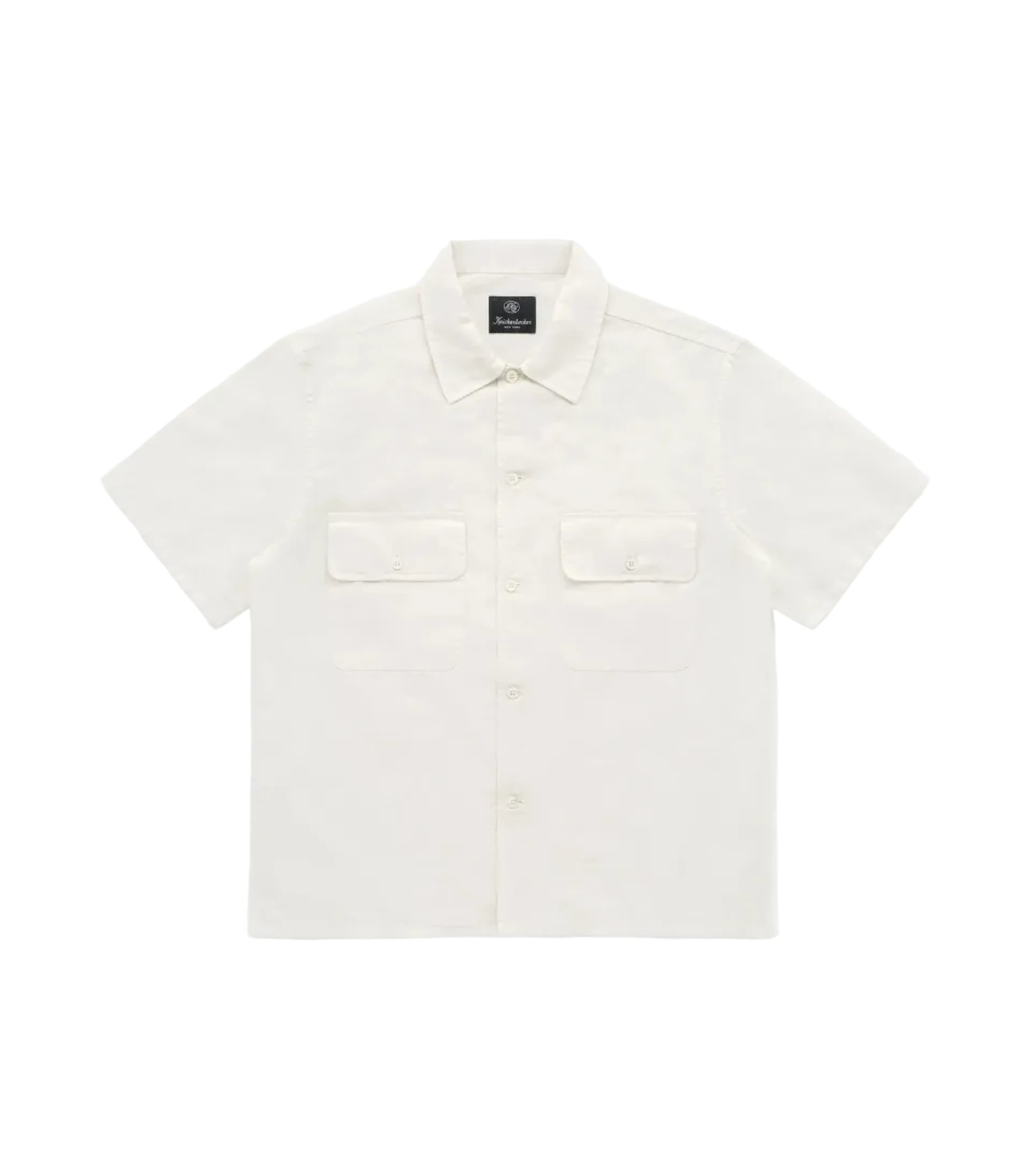 White shirt with a small black label on a white background