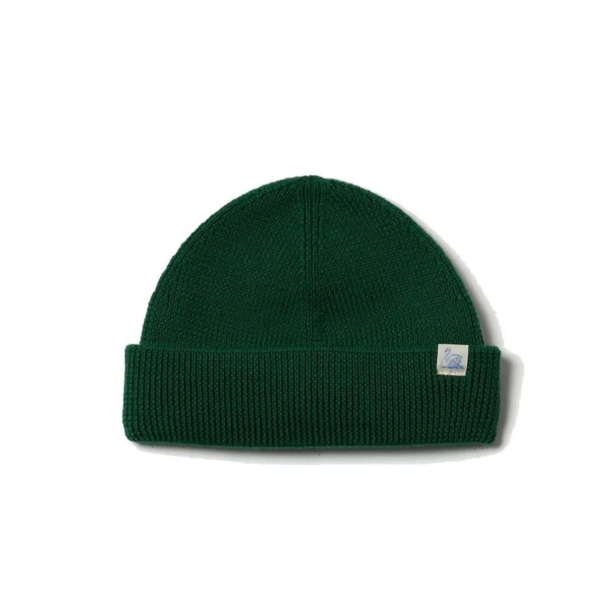 A dark green ribbed knit beanie hat with a small white square brand tag on the side, displayed against a clean white background.